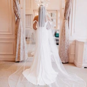 The Amour single tier classic tulle veil with a satin edge and in a flattering love-heart shape is a bestseller. Click to shop.