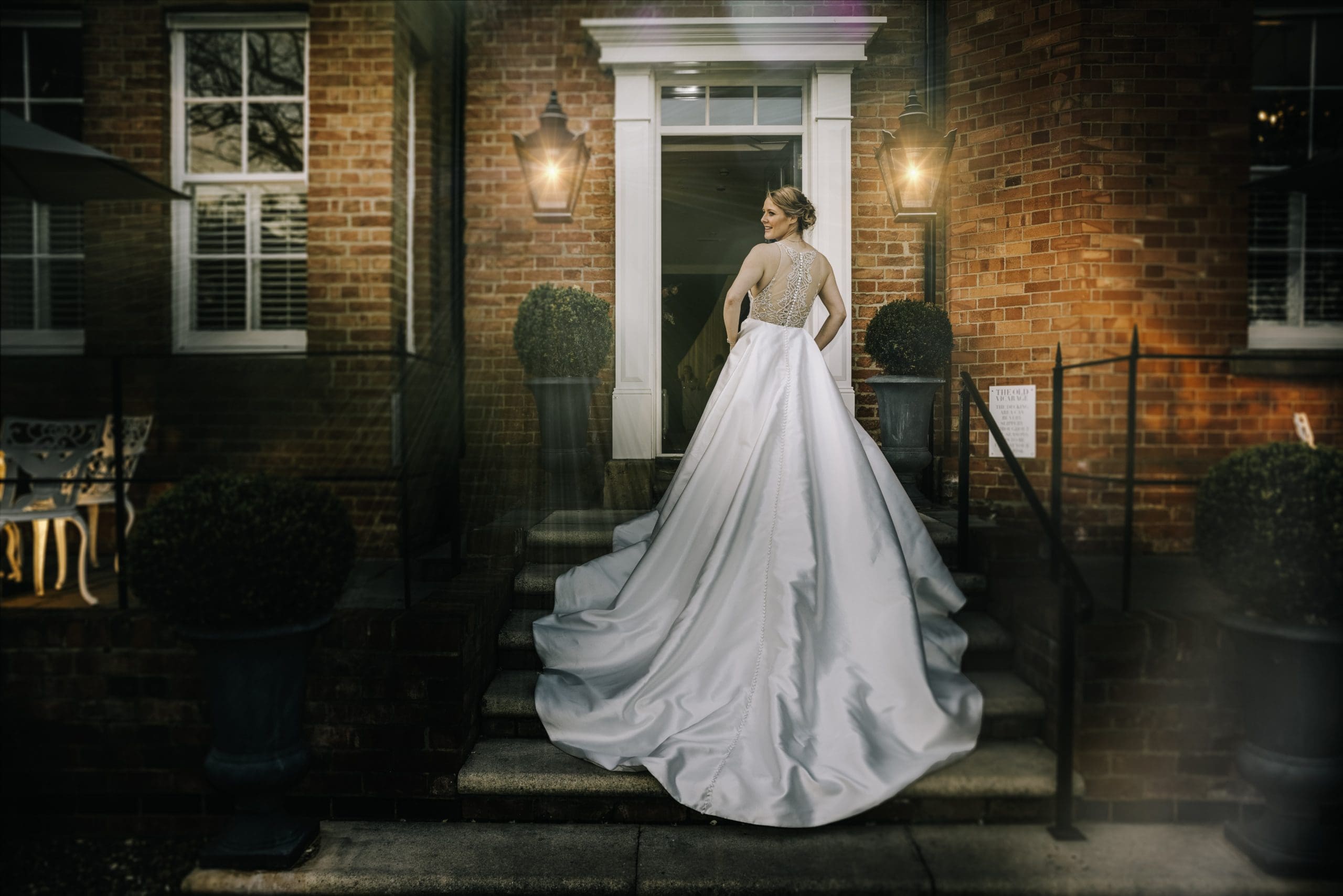 Bride shows off the back of her beautiful Style 8937 by Justin Alexander<br />
wedding dress